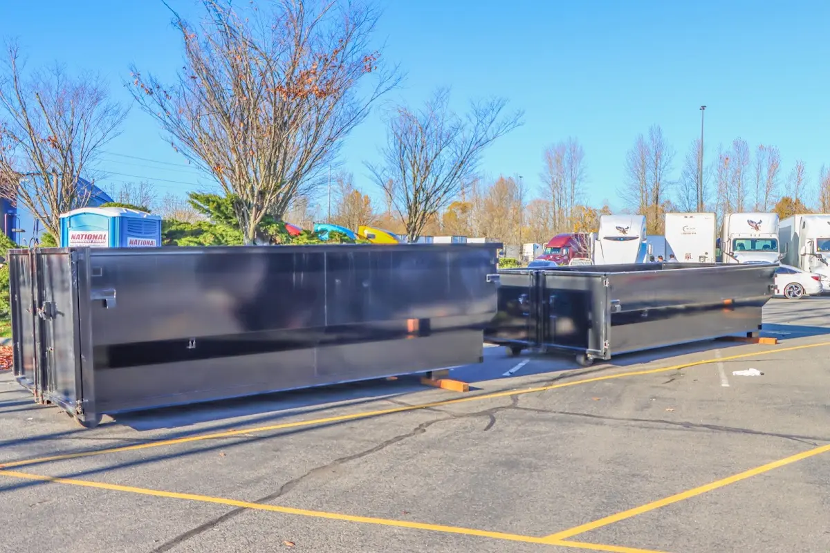 Professional dumpster rental service with roll-off container on residential driveway in Hermosa Beach